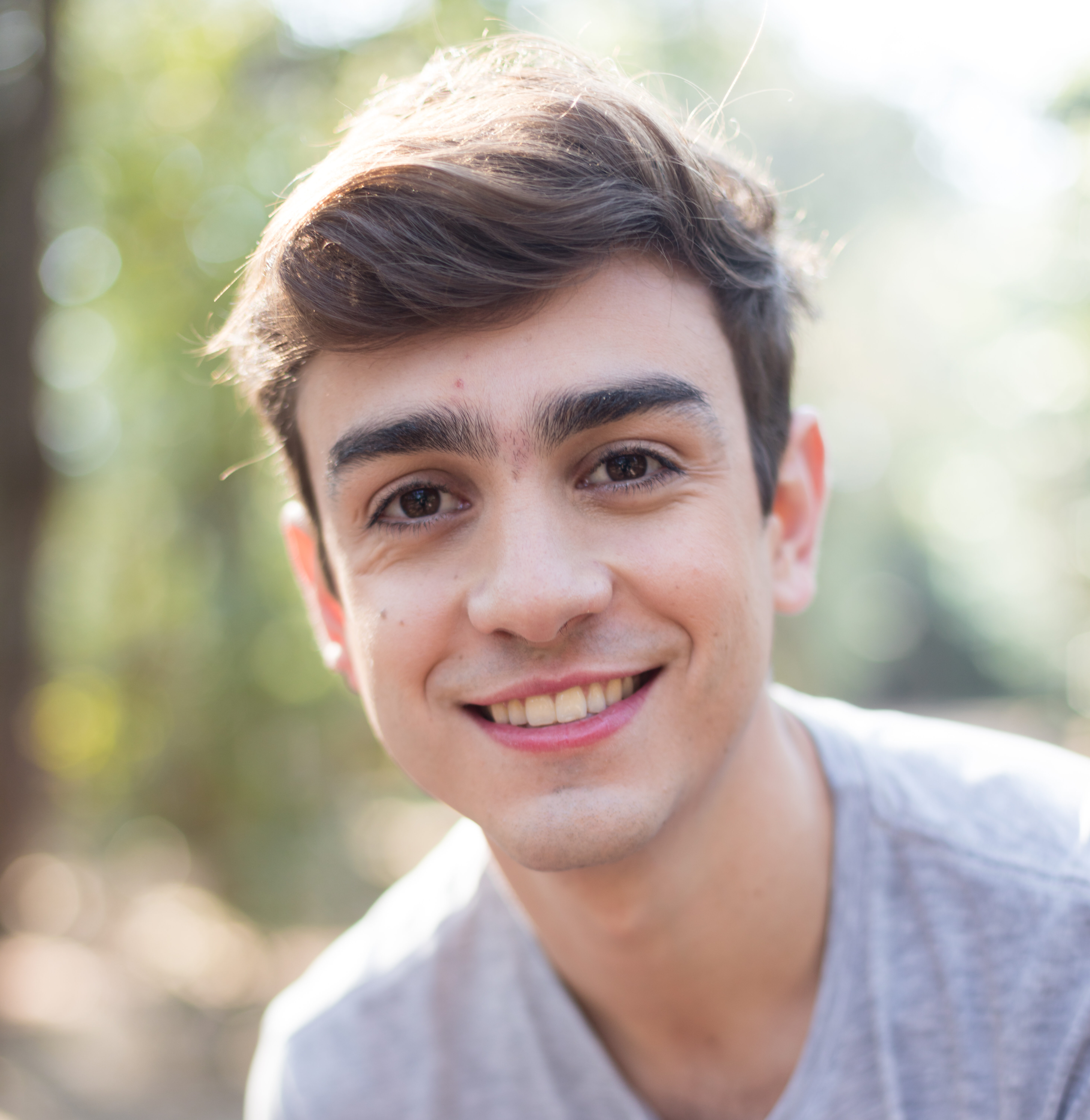 Home smiling teen with grey t shirt park